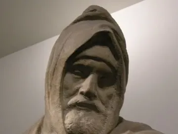 Detail of The Deposition showing a bearded hooded figure looking downward, with the top of another figure visible below.