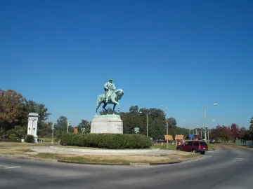 Gen. Beauregard equestrian statue on a stone pedestal in a grassy traffic circle