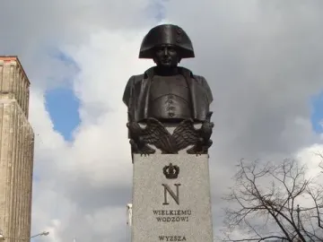The Emperor Napoleon I Memorial bust on a stone plinth with crowned N and eagle reliefs in Warsaw.