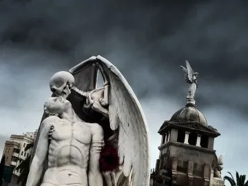 The Kiss of Death sculpture showing a winged skeleton leaning over a kneeling man and kissing his forehead.