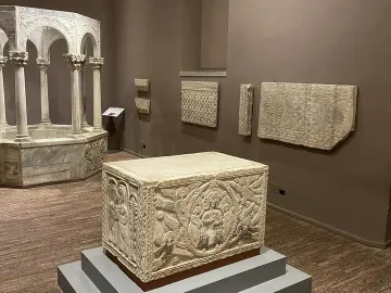 Baptistry of Callistus, an octagonal stone baptismal font with slender columns, arches, and carved decorative patterns.