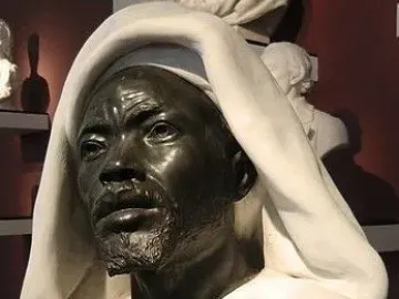 Salem, Negro of Sudan sculpture showing a man’s head and shoulders with a draped white hood.