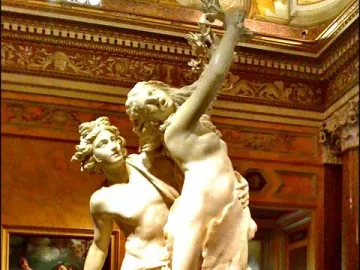 Apollo and Daphne marble sculpture showing two figures in a dramatic pose, with Daphne transforming into a laurel tree.