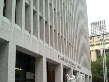 The Quest, a white sculptural fountain with intertwined human figures in a rectangular pool.