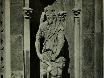 Stone relief of Abraham and Isaac, showing an older bearded man standing over a crouching, seminude younger figure in a carved niche.
