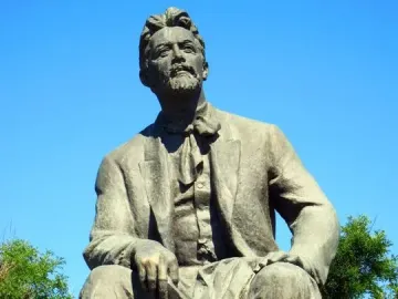 Chekhov Monument showing a seated bronze statue of Anton Chekhov holding a book and looking upward.