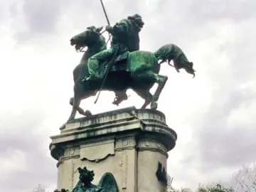 Monument to Giuseppe Garibaldi with a mounted statue atop a graffiti-covered stone pedestal in Buenos Aires.