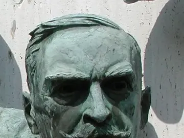Polio Hall of Fame sculpture of Karl Landsteiner with a weathered bronze head and shoulders, showing a handlebar mustache and deep-set eyes.