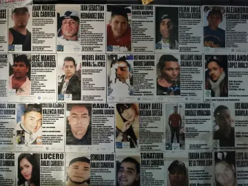 Wall covered with missing person posters at The Roundabout of the Disappeared.