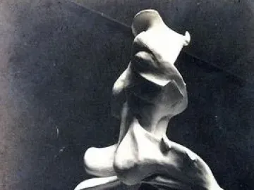 Unique Forms of Continuity in Space, a light-colored abstract sculpture in dynamic forward motion