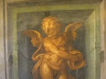 A winged putto standing on a dolphin and holding a vessel, painted within a decorative niche.