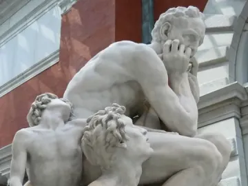 Ugolino and His Sons marble sculpture showing a distressed seated man with two emaciated sons pleading around him