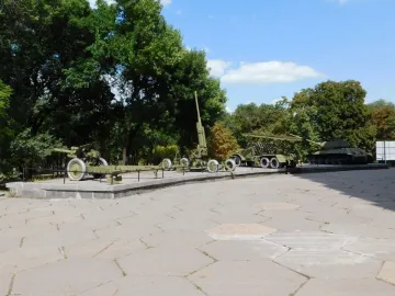 Battle of the Dnieper Diorama with a tank, rocket launcher, and artillery pieces displayed outdoors.