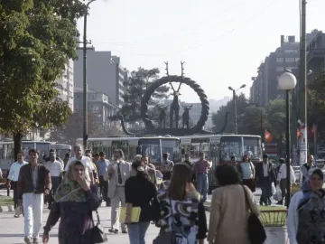 Hittite Sun Disk Monument with animal figures on a landscaped base in an urban setting.
