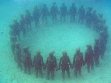 The Molinere Underwater Sculpture Park’s ring of human-like figures standing hand in hand on the seabed.