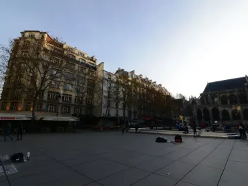 The Stravinsky Fountain with colorful whimsical sculptures spraying water in a Paris square.