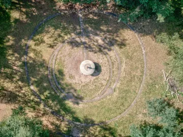 Aerial view of the UFO Memorial showing a circular ground design with a central pedestal and concentric rings.