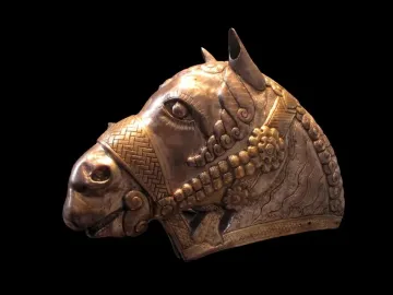 Sassanian horse head sculpture in profile with silver-toned metal and gold embellishments.