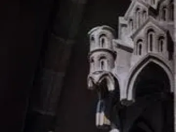 The Bamberg Horseman statue shown against a dark Gothic archway.