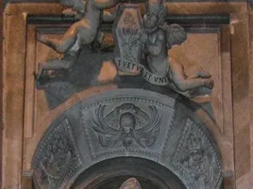 Marble tomb monument to Countess Matilda of Tuscany with a draped female figure in an arched niche, flanked by putti and a crest.