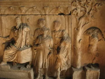 The Plutei of Trajan marble relief showing draped figures beside a tree and an altar with an eagle.