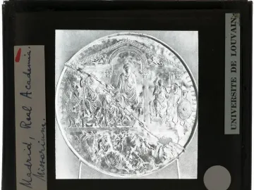 Disc of Theodosius shown as a circular relief with an enthroned emperor and attendants, cracked diagonally and mounted in a black frame.
