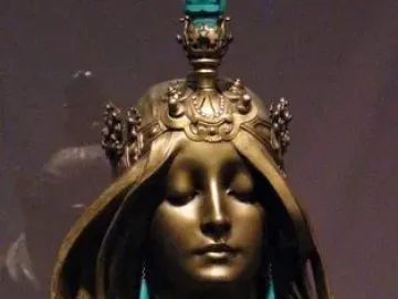 Nature bronze bust of a serene woman with closed eyes, flowing hair, and a jeweled crown.