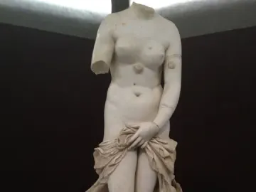 Venus Landolina, a headless white marble female statue with a missing right arm, holding drapery over her lower body.
