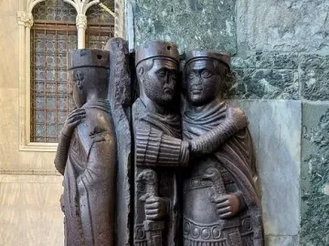 Portrait of the Four Tetrarchs, a dark reddish-purple porphyry sculpture of four stylized figures embracing in two pairs.