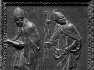 Relief panel from Donatello\'s Door of the Apostles showing two robed haloed figures, one holding a book and the other a staff.