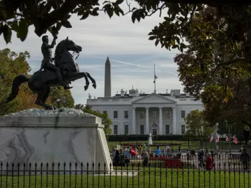 Andrew Jackson Statue on a tall stone pedestal with the White House and Washington Monument in the background