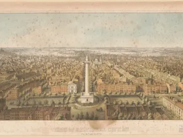 The Washington Monument rises above a Baltimore cityscape, surrounded by streets and buildings with water and hills in the distance.