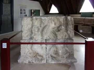 Stone relief blocks from the Pilier d\'Yzeures-sur-Creuse displayed in a museum setting.