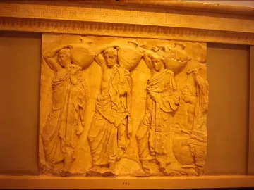 Parthenon metope stone relief with draped figures carrying large vessels