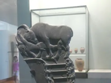 Bull Palette carved stone fragment showing a bull above a fallen figure and stepped scenes below.