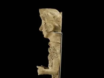 Lady of Ibiza sculpture showing a standing female figure in profile with an elaborate headdress and decorated attire.