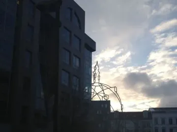 Memoria Urbana, a skeletal church outline silhouetted against a cloudy sky in Berlin.