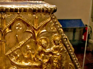 Gilded relief on the Sant Cugat Casket showing figures in a boat, standing figures, and gothic arches.