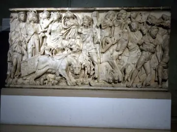 Roman marble relief on the Sarcophagus of the Triumph of Bacchus, showing a crowded scene with draped and partially nude figures and large felines.