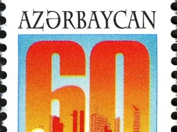 Peace Dove emblem on an Azerbaijani postage stamp with a large 60 and an urban background.