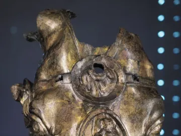 Fragmented gilded bronze horse head from Waldgirmes with weathered surface and relief details on the forehead