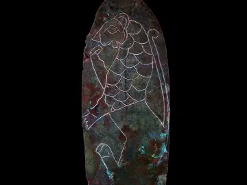 Spear of Lugal with an oxidized metal surface and a white line drawing of a feline creature etched on it.