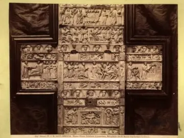 The Brescia Casket, an ivory casket with dense relief carvings arranged in horizontal panels and framed by dark wood.