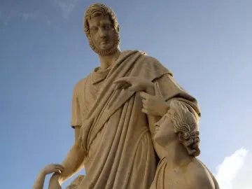 Canapone sculpture with a standing bearded man in classical robes, a seated woman with a baby, and a child at his side.