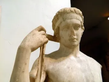 Farnese Diadumenos marble statue of a young athlete tying a ribbon around his head.
