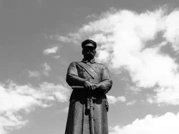 Józef Piłsudski Monument showing a military figure on a granite pedestal with an engraved name and national emblems.