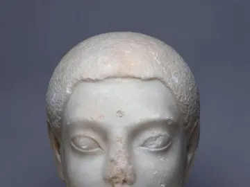 Sabouroff Head sculpture of a male head in white stone with delicate features and textured hair.