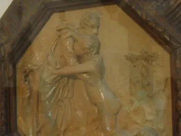 Creation of Eve terracotta relief showing a draped figure embracing a smaller nude figure above a reclining nude figure.