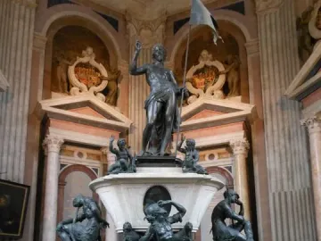 Mausoleum of Prince Ernst with a marble and bronze resurrection monument featuring a standing male figure holding a flag, surrounded by smaller figures.