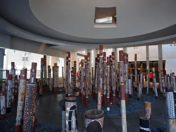 Aboriginal Memorial installation of painted vertical poles in a gallery space